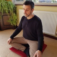 Glyn meditating cross-legged