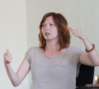 Young woman gesturing while teaching